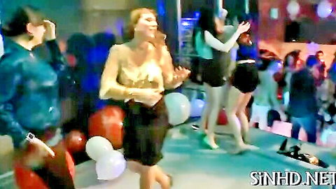 Group of women dancing erotically at a club party, short skirts and balloons