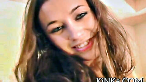Seductive brown-haired babe smiling with glossy lips in close-up tease