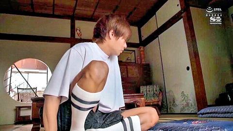 Yasui Kaoru kneeling in oversized white tee and striped socks, JAV solo tease