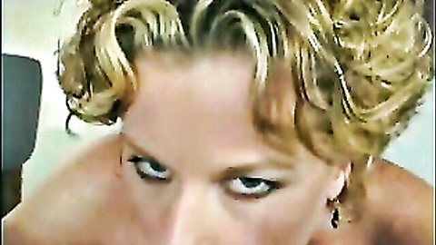 Close-up of blonde mature woman with curly hair and intense gaze