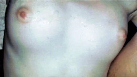 Close-up of pale tits with pink nipples dripping thick white cum