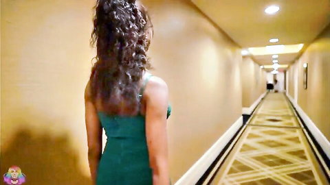 Curvy ebony babe in backless green dress walks down hotel hallway teasing her ass