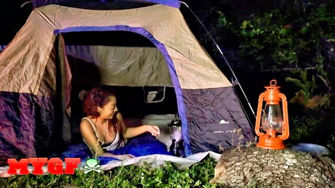 Sarah Lace in revealing tank top inside open tent by lantern light