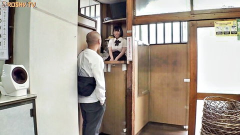 Japanese schoolgirl in uniform at public bath counter with older bald man