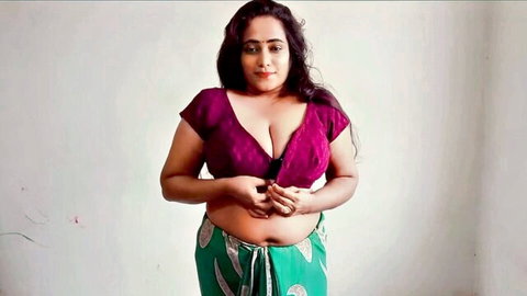 Curvy Desi aunty in low-cut purple blouse teasing with cleavage