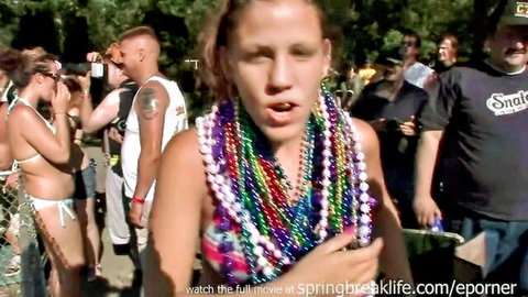 Amateur girl in bikini and colorful beads at spring break party