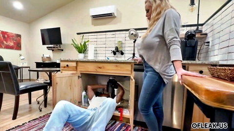 Blonde MILF housewife watches black plumber fix sink under kitchen counter