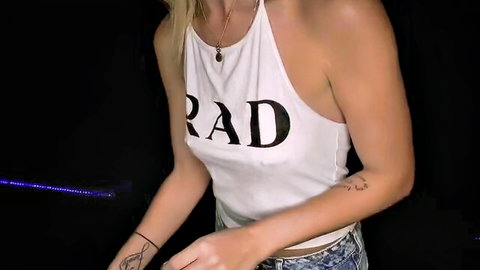 Blonde babe in tight RAD halter top revealing underboob and arm tattoos in neon club