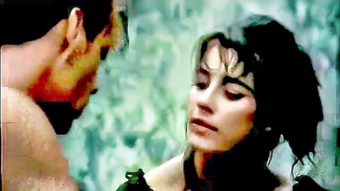 Tarzan and brunette jungle woman in passionate close-up embrace