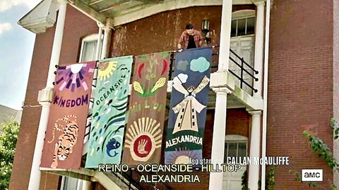 The Walking Dead S9E13 exterior scene with community banners: Kingdom, Oceanside, Hilltop, Alexandria