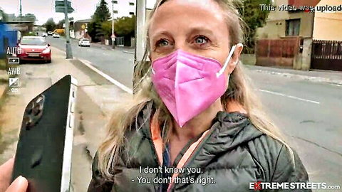 Blonde woman in pink mask and jacket surprised on street, Extreme Streets vaginal prolapse