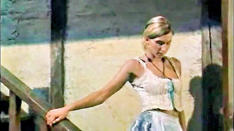 Blonde woman in white lacy corset and blue skirt posing seductively on railing