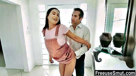 Smiling Asian stepdaughter in pink dress embraced by stepmom's boyfriend in taboo freeuse scene