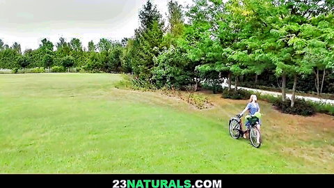 Kaisa Nord blonde babe with fake tits posing by bike in lush garden
