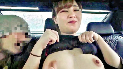 Asian woman with massive tits topless in car, ready for blowjob