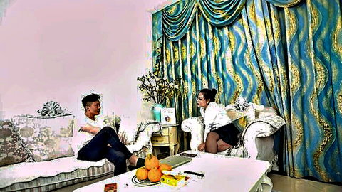Chinese stepmother in white blouse and black skirt chats with stepson