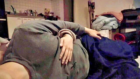 Japanese woman in gray hoodie lying back for intense handjob edging