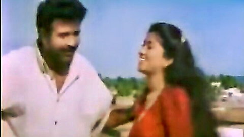 Indian hunk in white shirt holds sexy desi woman's arm smiling passionately outdoors
