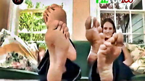 Barefoot beauty teasing with soles and toes in seductive pose