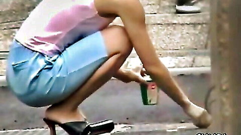 Hot Asian woman squatting in public with upskirt view in blue skirt and heels