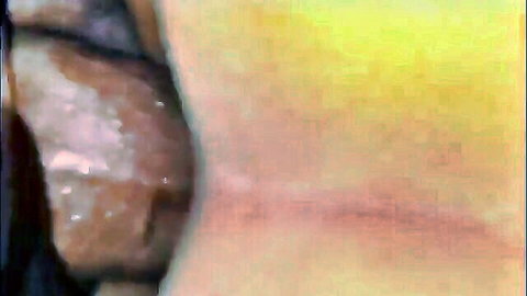 Blurry amateur close-up of pale ass cheeks spread by hand exposing tight pink anus