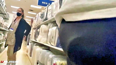 Hot Asian woman in tight khaki pants showing juicy ass in bedding store aisle