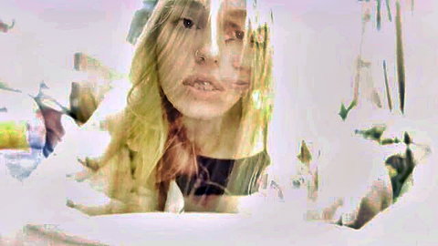 Blonde woman with intense gaze and nose piercing in hazy erotic close-up