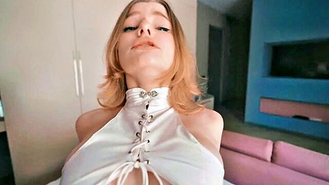 Blonde young babe teases with deep cleavage in laced white halter top