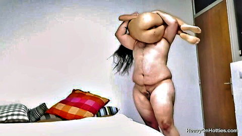 BBW holds petite naked girl upside down with face buried in hairy pussy