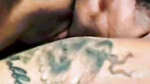 Tattooed mature man in close-up intimate skin embrace
