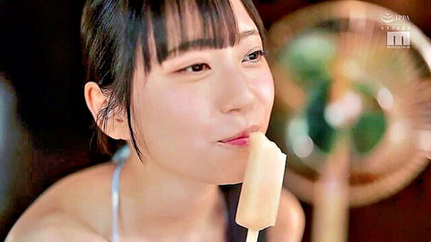 Asian beauty in teasing close-up licking white popsicle suggestively