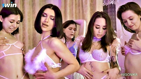 Group of slim European women in feathered pink lingerie posing seductively