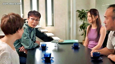 East Asian couple and friends in casual clothes chatting intimately at tea table