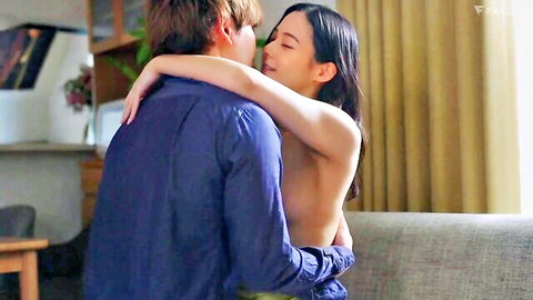 Slim Asian woman topless, embraced intimately by man in JAV scene