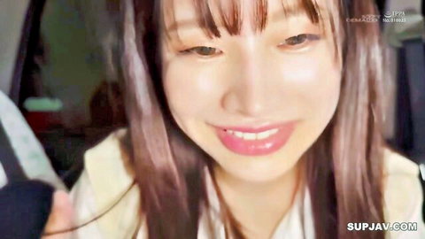 Smiling Asian woman with long hair in taxi car interior