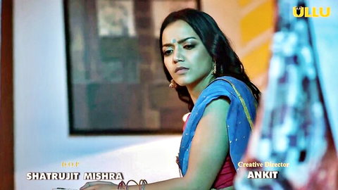 Sexy Indian housewife in blue saree gazes seductively in Ullu series promo