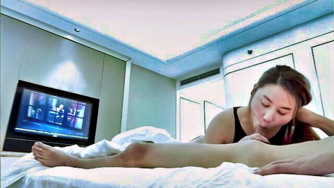 Asian slim woman in black tank top kissing intimately on bed