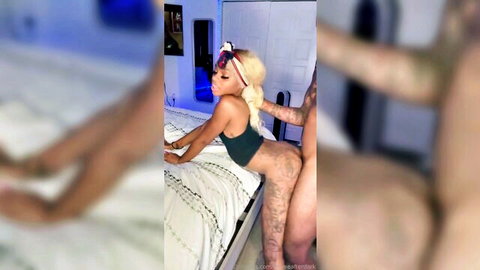 Curvy blonde with tattoos bent over in green top, hand grabbing big ass