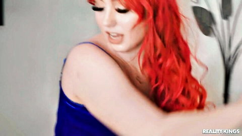 Arietta Adams redhead in blue lingerie seductive pose