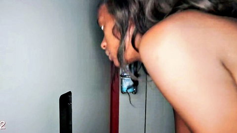 Ebony woman nude in gloryhole pose, leaning back view curves