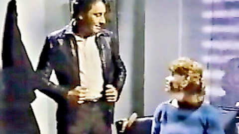 Vintage 1984 Trinity Brown scene: man in leather jacket faces curly-haired woman in sweater