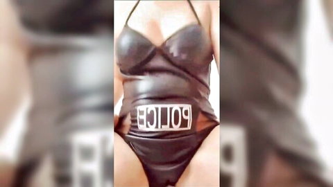 Curvy woman in tight latex police uniform posing seductively with legs spread