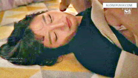 Cayenne Klein relaxing on bed in cozy sweater, eyes closed seductively