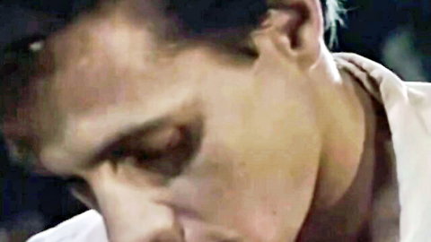 Intense close-up of male actor in white shirt from 1989 adult film Remote Control with Carol Cummings