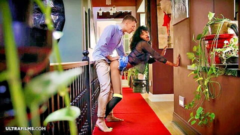 White guy grips ebony babe's ass as she bends over in sheer top and shorts for passionate hallway doggy tease