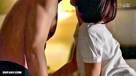 Shirtless muscular man passionately kissing Asian woman's neck in bed
