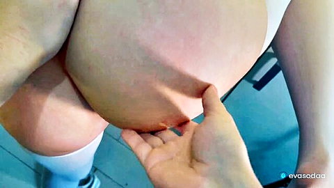 POV closeup of huge pregnant belly grabbed by manicured hand