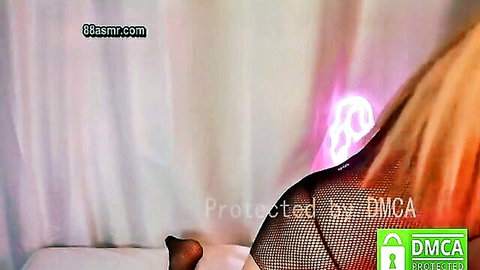 Blonde in fishnet top teasing sideboob with purple glow on ASMR webcam