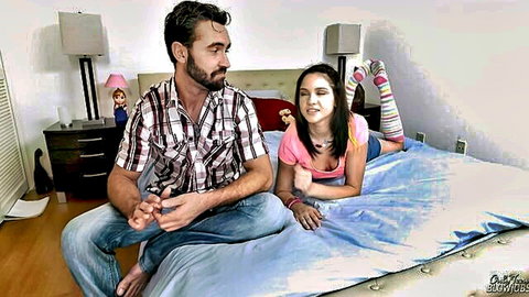 Cadey Mercury lying on bed gazing at man, implying oral tease