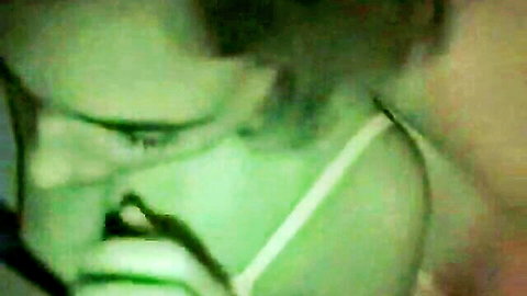 Intense closeup of amateur girl in green surgical mask with seductive eyes teasing blowjob